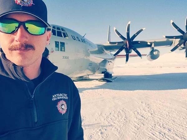 Photo of Buddy Pierce in Antartica in front of large airplane