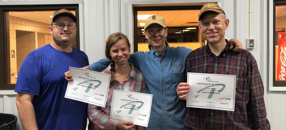 Picture of Whiting family holding welding class certificates