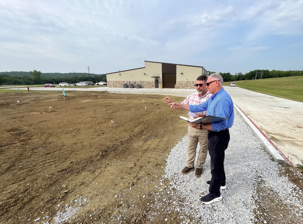 Jamie Perry, PTC Lineworker Academy Instructor, and Jim Lawson, Business and Industry Coordinator, consider plans for the new pole yard installation outside of the new Industrial Training Center.