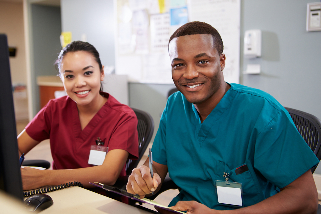 Photo of two nurses sitting at a desk