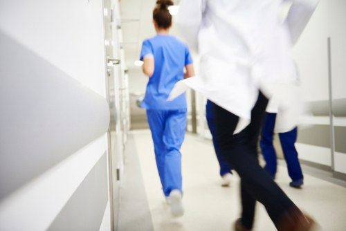 Picture of a nurse and doctor running down a hallway in an emergency