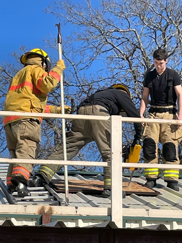 Image of students learning to cut through roof for fire ventilation
