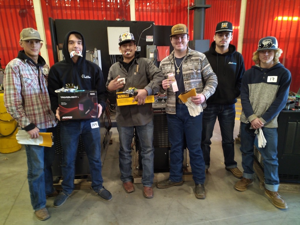 Image of welding students with awards and prizes.