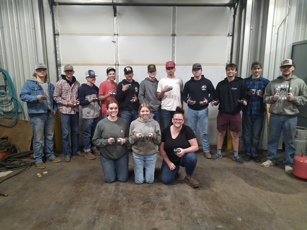Group photo of welding students holding their certification cards