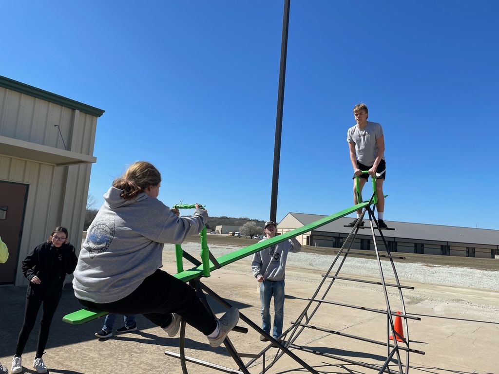 Photo of students on a giant teeter totter