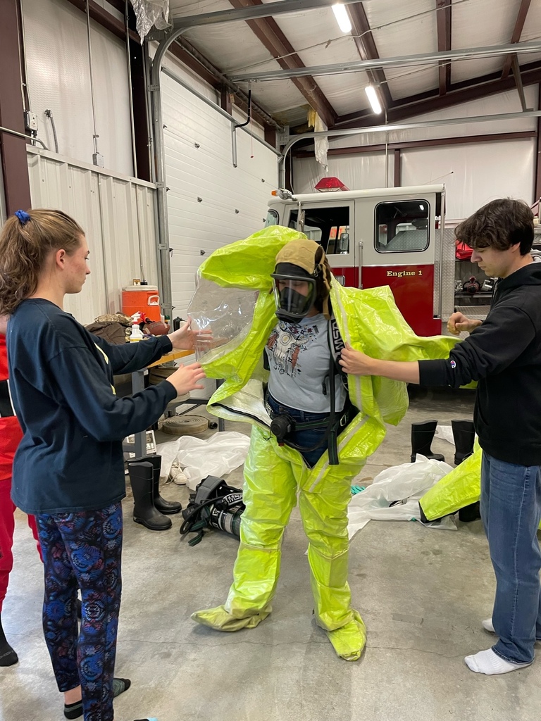 Students putting on PPE equipment for hazardous waste cleanup practice