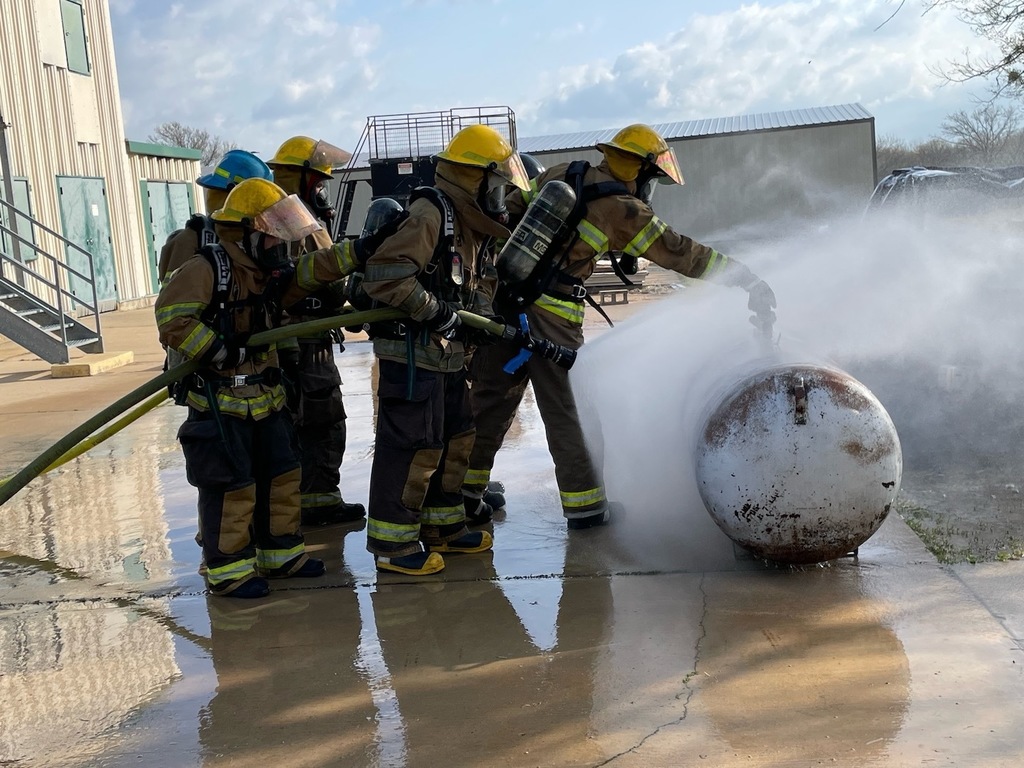 Fire students performing mock propane take fire maneuver