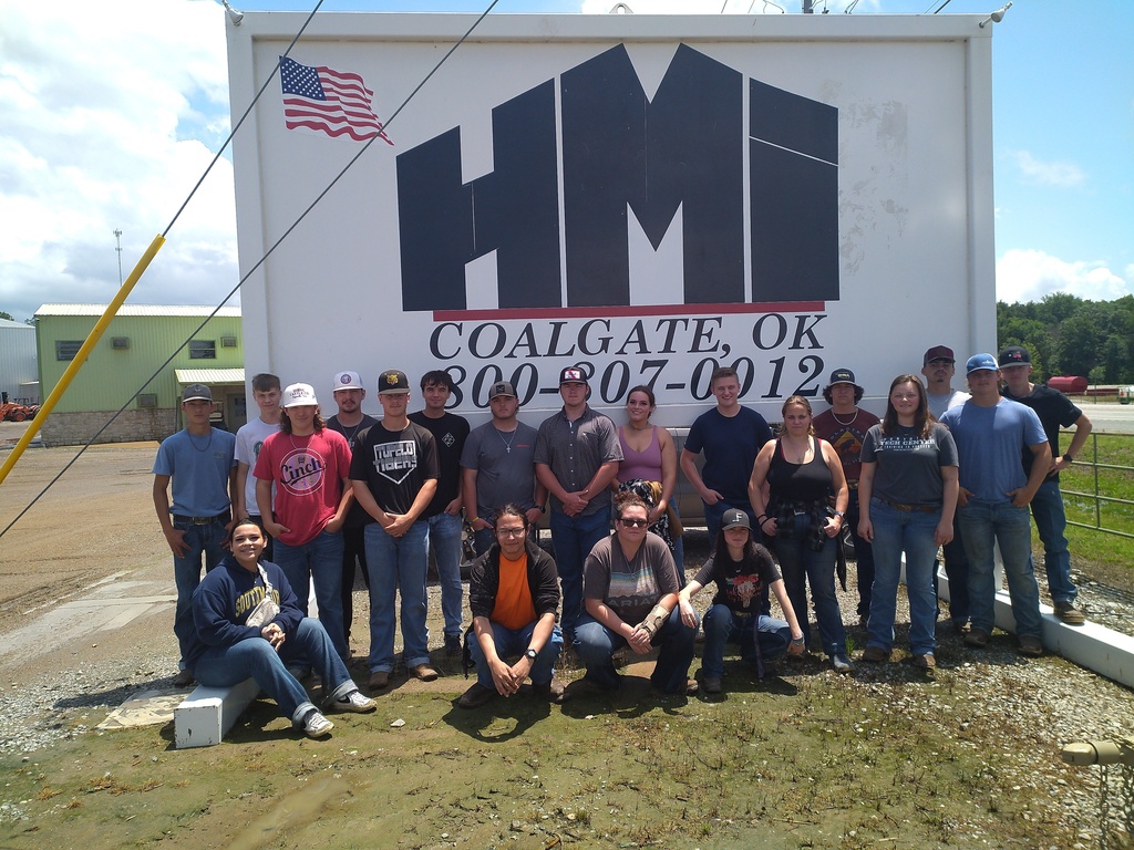 Group of welding students in front of a sign that reads HMI
